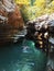 A girl swims in a turquoise river surrounded by canyons and forests. Canyon white cliffs