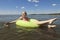 A girl swims in a yellow inflatable circle on the lake.