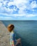 Girl in a swimsuit and Cape, on the beach against the beautiful sky