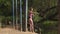 Girl in a swimsuit jumping from pier into water