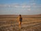 A girl in a swimsuit is walking at sunset over a dry salt lake