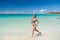 Girl swimwear bikini run wave azure ocean beach. Vacation luxury tropic ocean beach resort. Run through magical