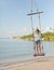 Girl on a swing against the background tropical seasca