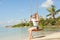 girl on a swing against the background tropical seasca