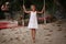 Girl on the swing on the beach in white dress