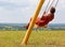 Girl swinging on a high swing. Beautiful view of the landscape