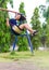 Girl swinging swing in the garden.