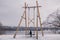 The girl swings on it and looks at the incredible view of Kyiv.