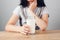 girl at the table holds a glass of milk