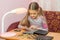 Girl at table leafing through the album with coins