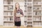 Girl with tablet in a home library with a ladder