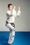 Girl, Taekwondo is martial Stoke hands in fists, focused, serious look in the Studio on isolated background