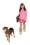 Girl take\'s dog for a walk carrying her laptop