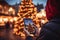 Girl take shot on smartphone Christmas tree on the city market place