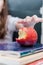 girl takes an apple snack during lessons