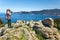 Girl takes picture of Bay Porto in Corsica Island