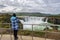 Girl takes picture of Godafoss waterfall from the mirador of the eastern bank