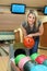 Girl takes two hands ball for playing bowling