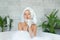 Girl taking bath with bubble foam at home.