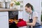 Girl taking cake with hot freshly baked muffins from the oven