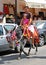 Girl taking a donkey ride Burro Taxi, Mijas, Spain.