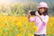 Girl taking photo mobile phones in flowers field