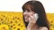 Girl talking on phone in field of sunflowers, summer tour of the countryside