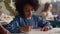 Girl talking with teacher in classroom. Smiling schoolgirl writing in notebook