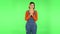 Girl talks about something then making a hush gesture, secret. Green screen