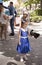 Girl with tame birds. Nearby there are participants of an attraction