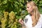 Girl tasting white wine among vineyards