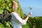 Girl tasting white wine among vineyards