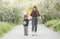 a girl teaches a boy to ride a skateboard