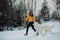 Girl teaches how to right run a dog in winter park. The girl with the Maremma . Forest on background