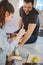 Girl teasing dog with food and boyfriend is smiling