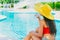 Girl teen drinking cool water relax at swimming pool
