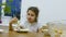 Girl teen eats food hungry lettuce at table