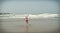 Girl or teen learning to ride a skimboard on the Oregon coast