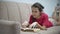 Girl teen reading a book lying on sofa indoors. girl kid reading a book lying on a sofa