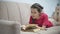 Girl teen reading a book lying on sofa indoors. girl kid reading a book lying on a sofa indoors