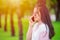 Girl teen on smartphone calling talking happy smile green outdor nature background