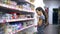 Girl teen in supermarket to buy food dairy yogurt