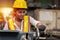 Girl teen worker african american working labor in industry factory with heavy steel machine