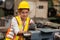 Girl teen worker african american working labor in industry factory with heavy steel machine