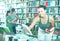 Girl teenager choosing book in shop