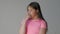 Girl teenager on a gray background depicts emotions