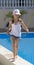 Girl teenager hurries on skirting of pool