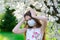 Girl teenager in protective medical mask in the spring among blooming garden. Quarantine coronavirus in Europe. Allergy to