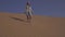 Girl teenager runs around the sand on the slope of the dune in Rub al Khali desert United Arab Emirates stock footage