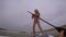 Girl teenager on stand up paddle board. Mainly cloudy
